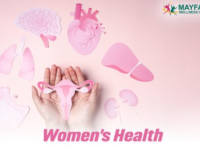 Hands holding a pink uterus illustration surrounded by other vital organ cutouts, representing women’s health awareness.
