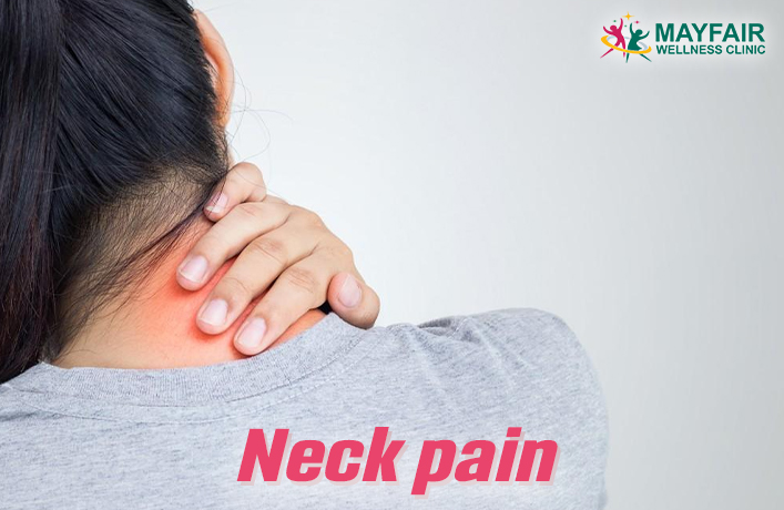 Person holding neck in pain, seeking neck pain relief – Mayfair Wellness Clinic